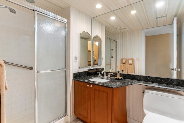 full bathroom with visible vents, a shower stall, toilet, and vanity