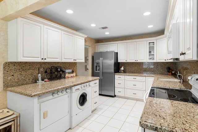 kitchen featuring stainless steel fridge with ice dispenser, light tile patterned floors, white electric stove, white cabinetry, and a sink