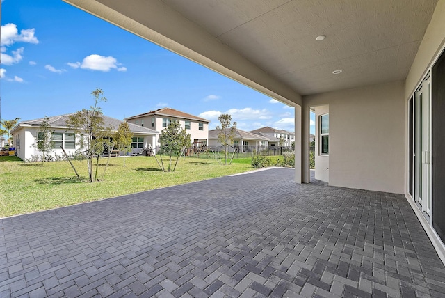 view of patio featuring fence and a residential view