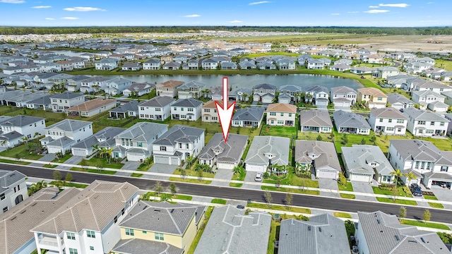 bird's eye view with a water view and a residential view