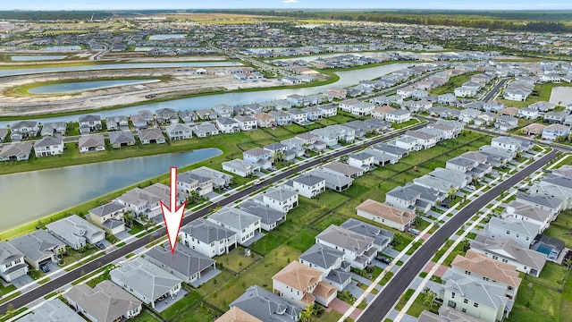 bird's eye view with a water view and a residential view