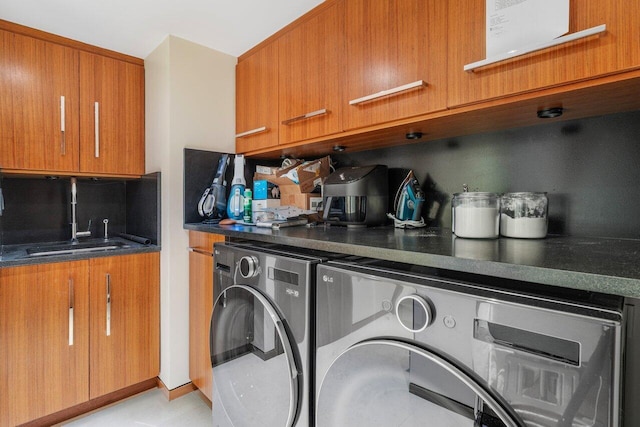 laundry room featuring washing machine and clothes dryer and a sink