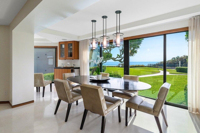 dining area featuring baseboards, wet bar, and an inviting chandelier