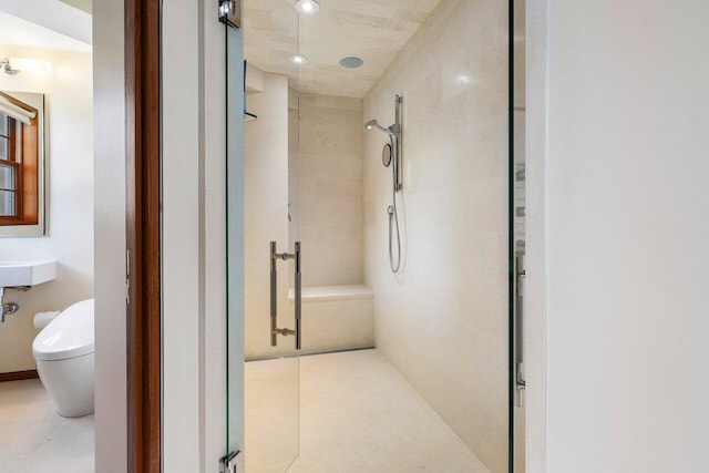 bathroom with toilet and a stall shower