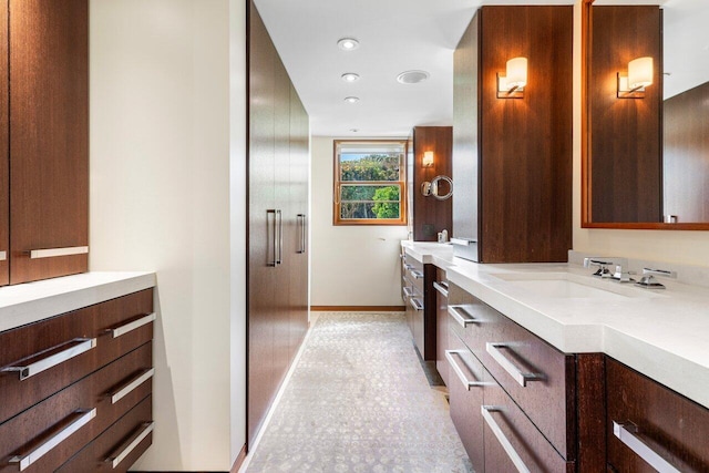 full bathroom with recessed lighting, vanity, and baseboards