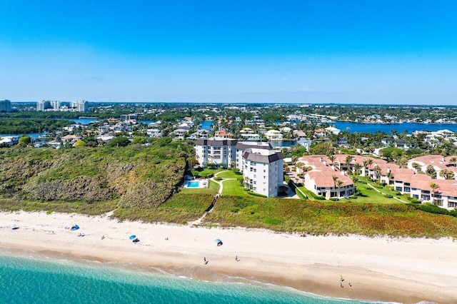 drone / aerial view with a water view and a beach view