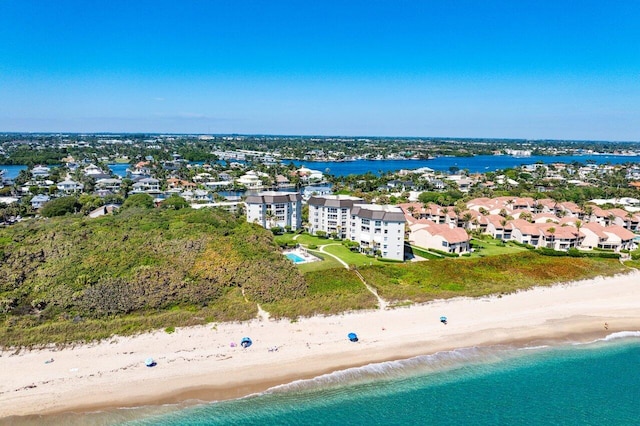 aerial view with a water view and a beach view