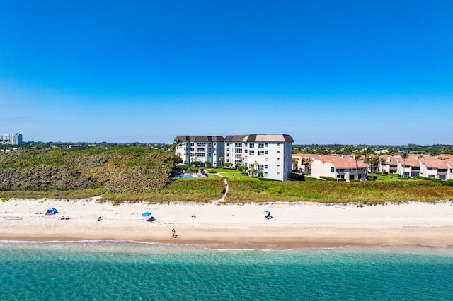 drone / aerial view featuring a water view and a view of the beach