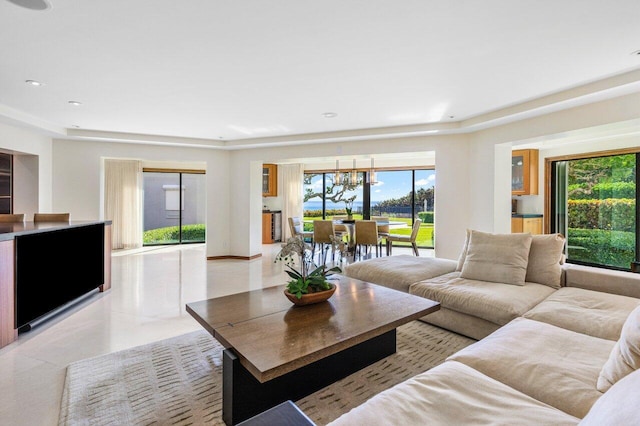 living room with an inviting chandelier and light tile patterned floors