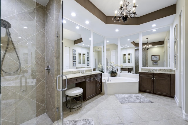 bathroom featuring a shower stall, a garden tub, recessed lighting, an inviting chandelier, and a sink