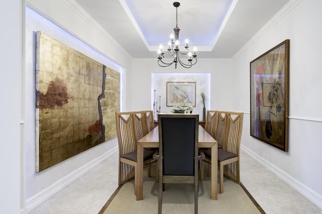 dining room featuring light tile patterned floors, an inviting chandelier, a raised ceiling, and baseboards