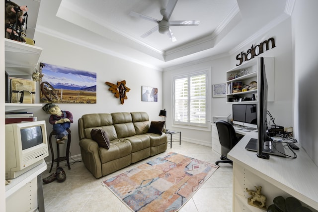 home office with crown molding, baseboards, ceiling fan, light tile patterned flooring, and a raised ceiling