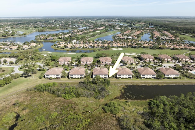 drone / aerial view featuring a residential view and a water view