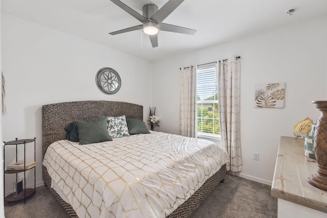 bedroom with a ceiling fan, carpet flooring, and baseboards