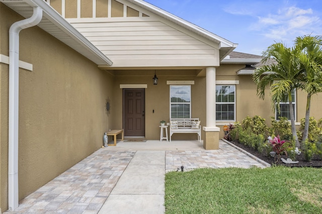 property entrance featuring stucco siding