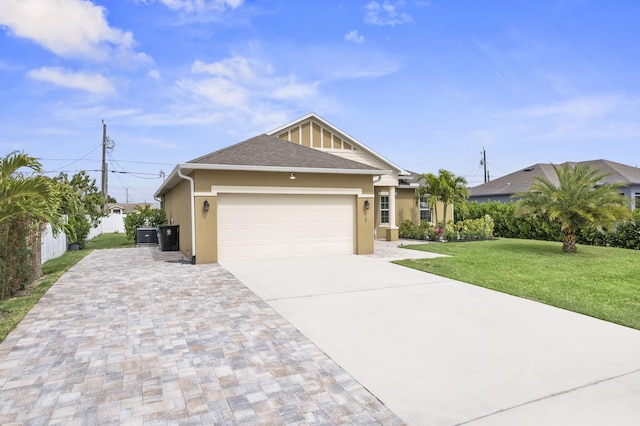 view of front of home featuring stucco siding, an attached garage, fence, driveway, and a front lawn