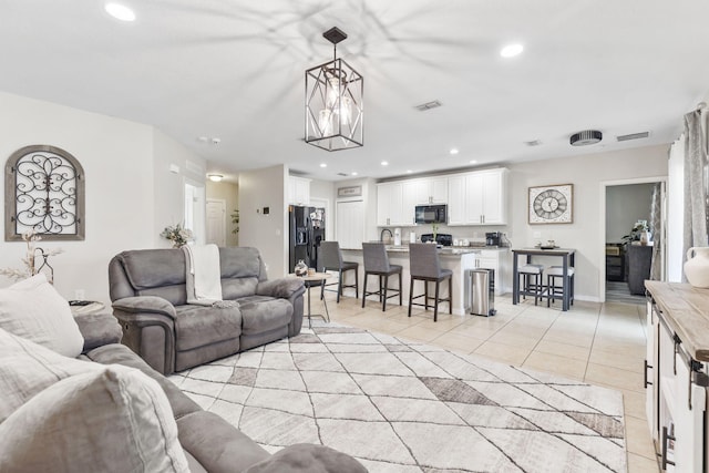 living area featuring recessed lighting, visible vents, and light tile patterned flooring