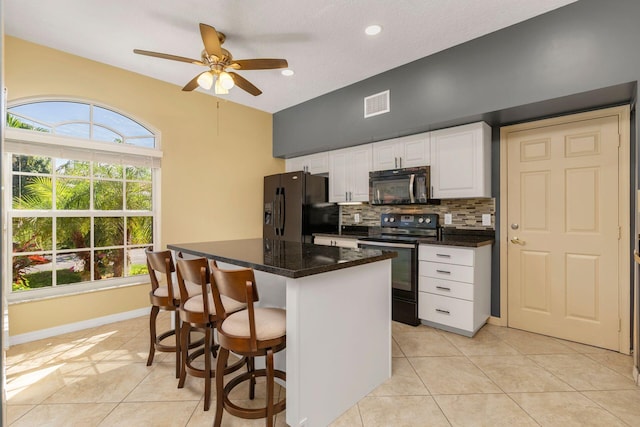 kitchen with light tile patterned floors, visible vents, black appliances, white cabinetry, and backsplash