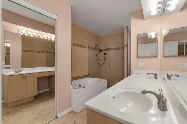 full bathroom featuring a garden tub, tile patterned flooring, a sink, and a shower stall