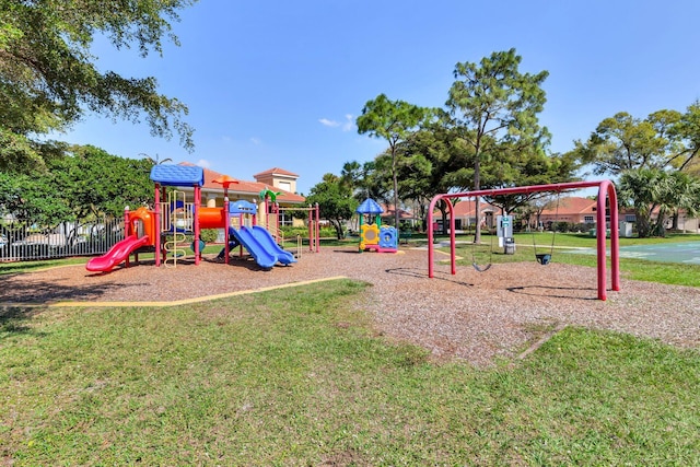 community play area with a yard and fence