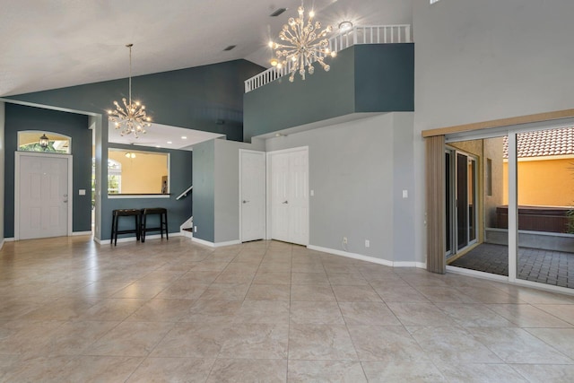 unfurnished living room featuring visible vents, baseboards, tile patterned floors, vaulted ceiling, and a notable chandelier