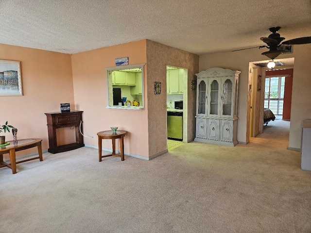 interior space featuring carpet floors, a textured ceiling, and baseboards