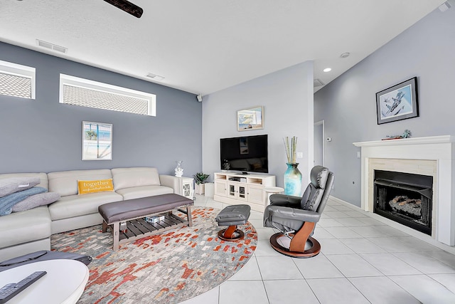 living area featuring recessed lighting, a fireplace, visible vents, and light tile patterned flooring