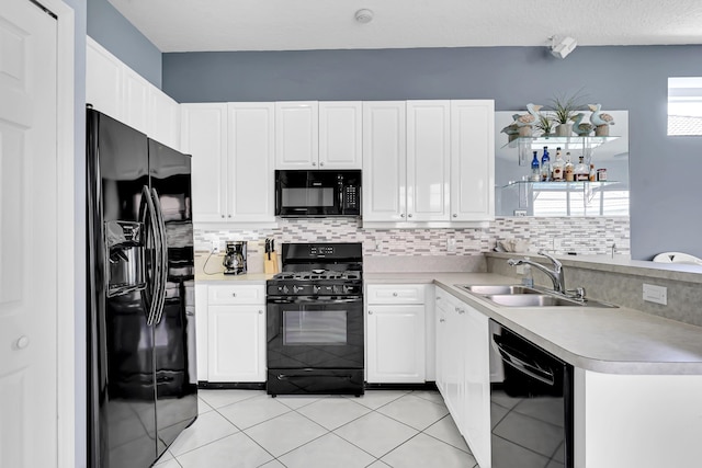 kitchen featuring light tile patterned floors, tasteful backsplash, light countertops, black appliances, and a sink