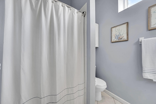 bathroom with a shower with shower curtain, tile patterned flooring, toilet, and baseboards