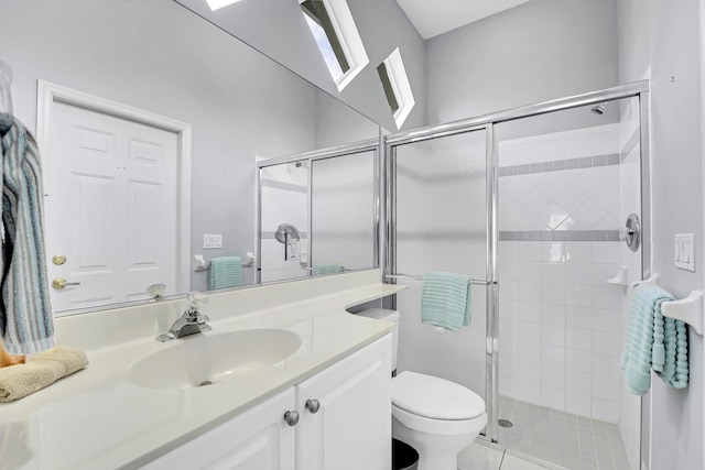 full bath featuring toilet, a stall shower, vanity, and tile patterned floors