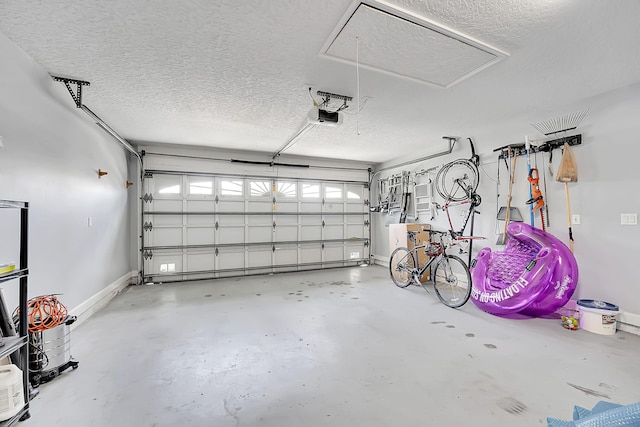 garage with baseboards and a garage door opener