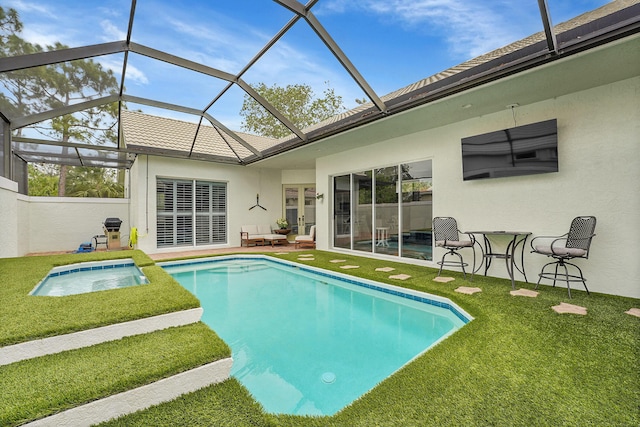 outdoor pool with a lawn, glass enclosure, and a patio