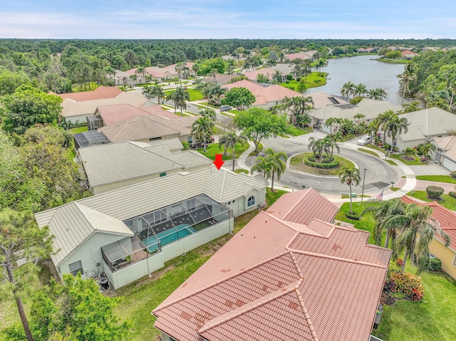 drone / aerial view with a residential view and a water view