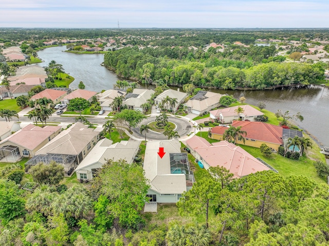 drone / aerial view featuring a water view and a residential view