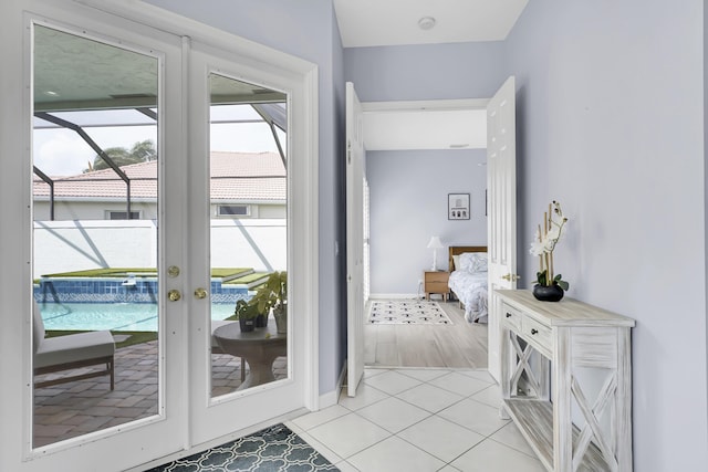 entryway with light tile patterned floors and baseboards