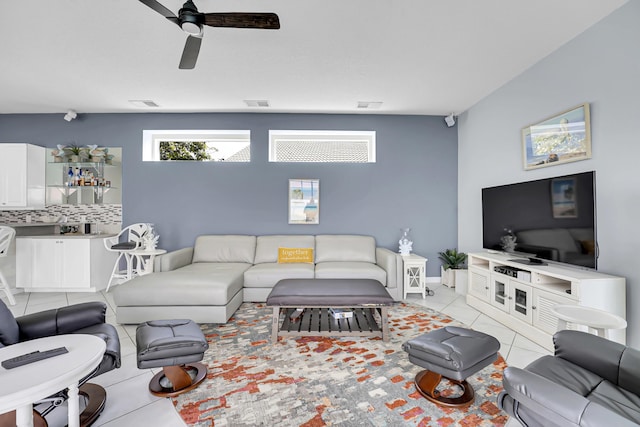 tiled living room featuring visible vents and a ceiling fan