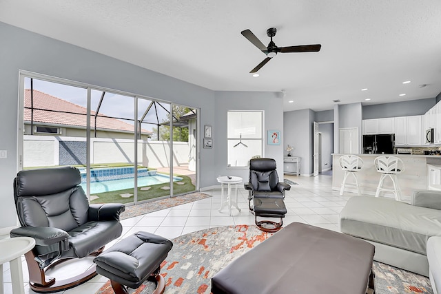 living room with light tile patterned floors, recessed lighting, a ceiling fan, a sunroom, and baseboards