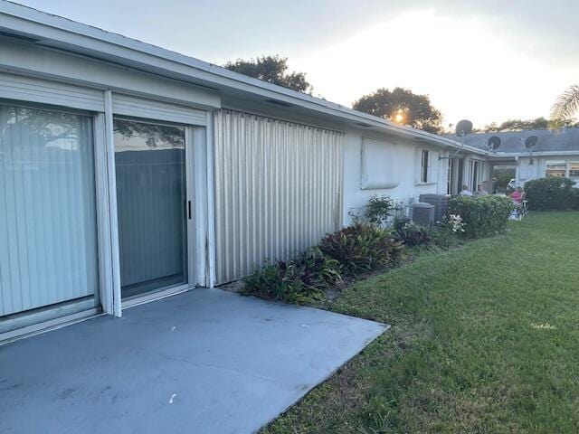 view of side of property with a lawn