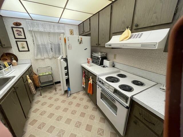 kitchen with range hood, a toaster, light countertops, a sink, and white appliances