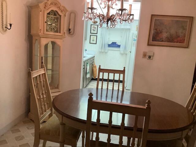 dining space featuring a notable chandelier
