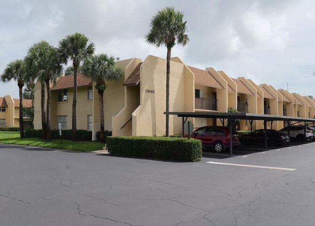 view of property featuring covered parking and a residential view