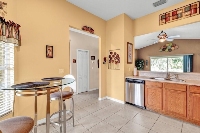 kitchen featuring dishwasher, light tile patterned floors, a sink, and visible vents