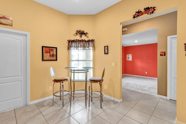 dining room with tile patterned flooring and baseboards