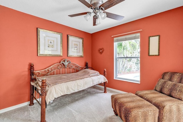 carpeted bedroom with baseboards and a ceiling fan
