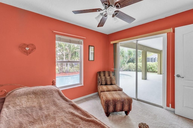bedroom with access to exterior, light carpet, ceiling fan, and baseboards