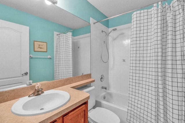 bathroom with a textured ceiling, shower / bath combo, vanity, and toilet