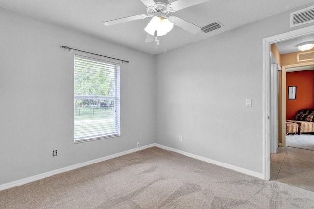 unfurnished room with light carpet, ceiling fan, and visible vents
