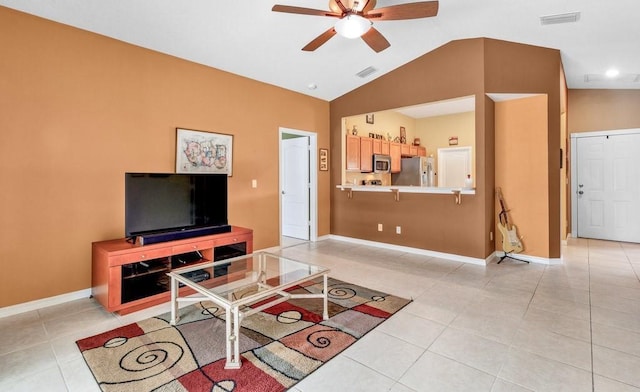 living area featuring light tile patterned floors, visible vents, ceiling fan, vaulted ceiling, and baseboards