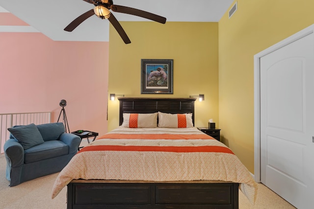 carpeted bedroom with visible vents and a ceiling fan