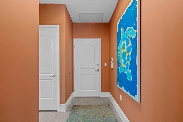 hallway featuring baseboards and visible vents